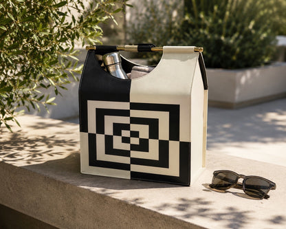 Kra Design luxury leather lunch basket with geometric pattern, black and cream, gold hardware, and modern handles.
