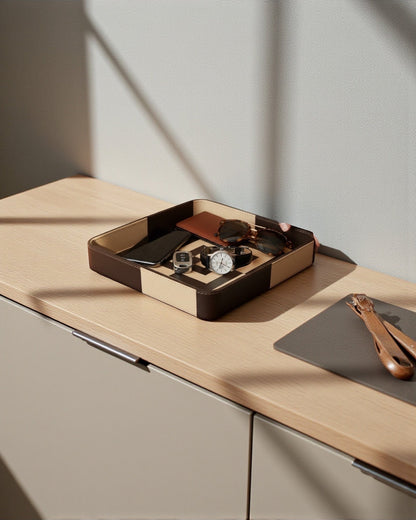 Kra Design luxury leather vanity tray with geometric detailing, holding a phone, watch, sunglasses, and wallet.